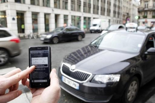 Brussels taxi drivers fly banners on cabs to call for action against Uber