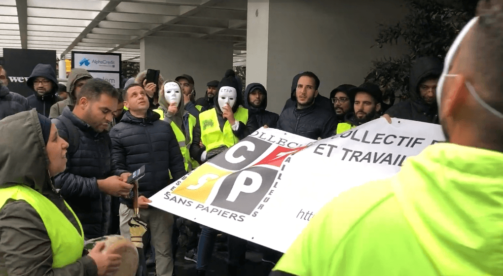 Undocumented workers protest in front of Brussels Minister for Employment's offices