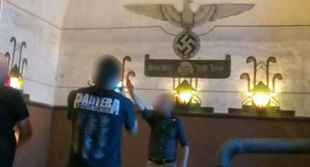 Member of extreme-right group performs Hitler salute in Breendonk Nazi prison camp