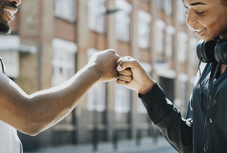 Fist bumping officially not considered high-risk contact