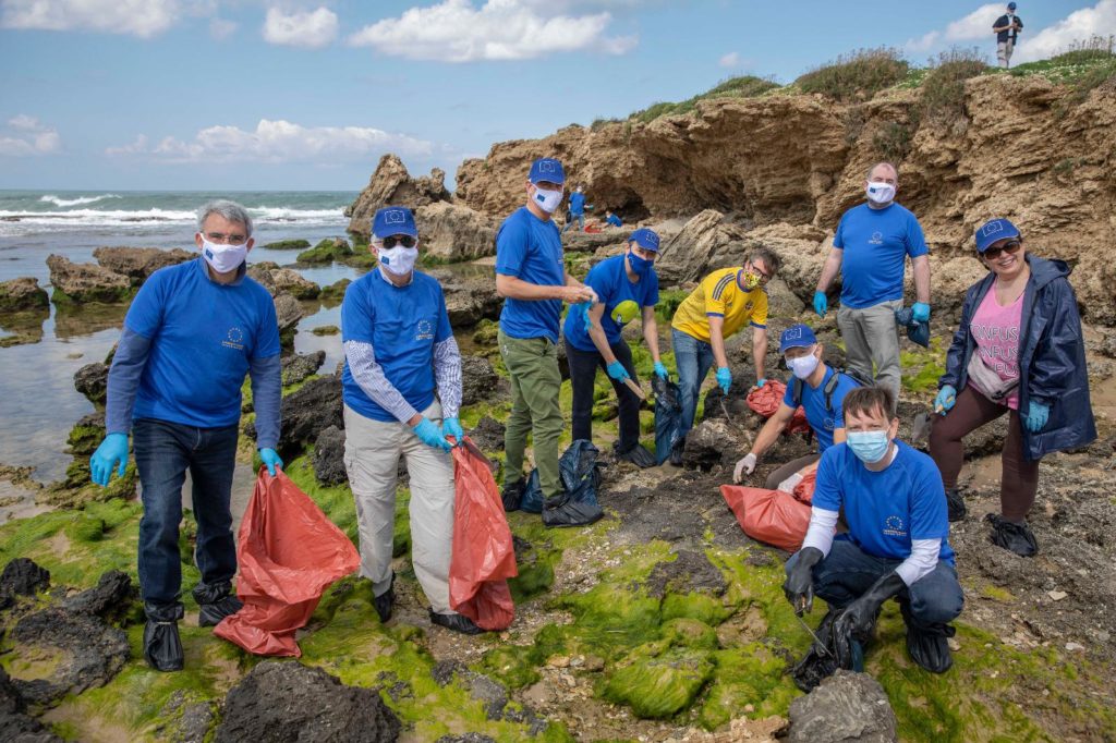 EU ambassadors clean Israeli beach after mysterious oil spill in the Mediterranean Sea