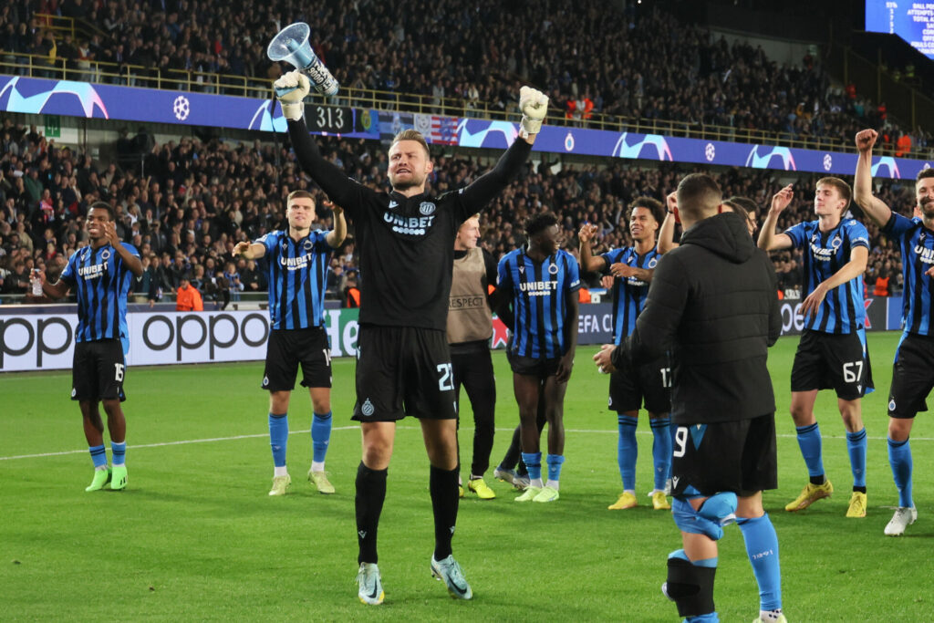 Club Brugge fans in the stands celebrate the result after the
