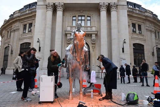 Green activists daub statue in Paris with orange paint