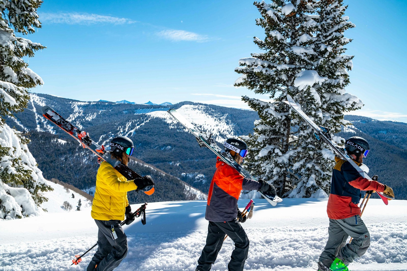 man in yellow jacket and black pants playing ski on snow covered ground during daytime