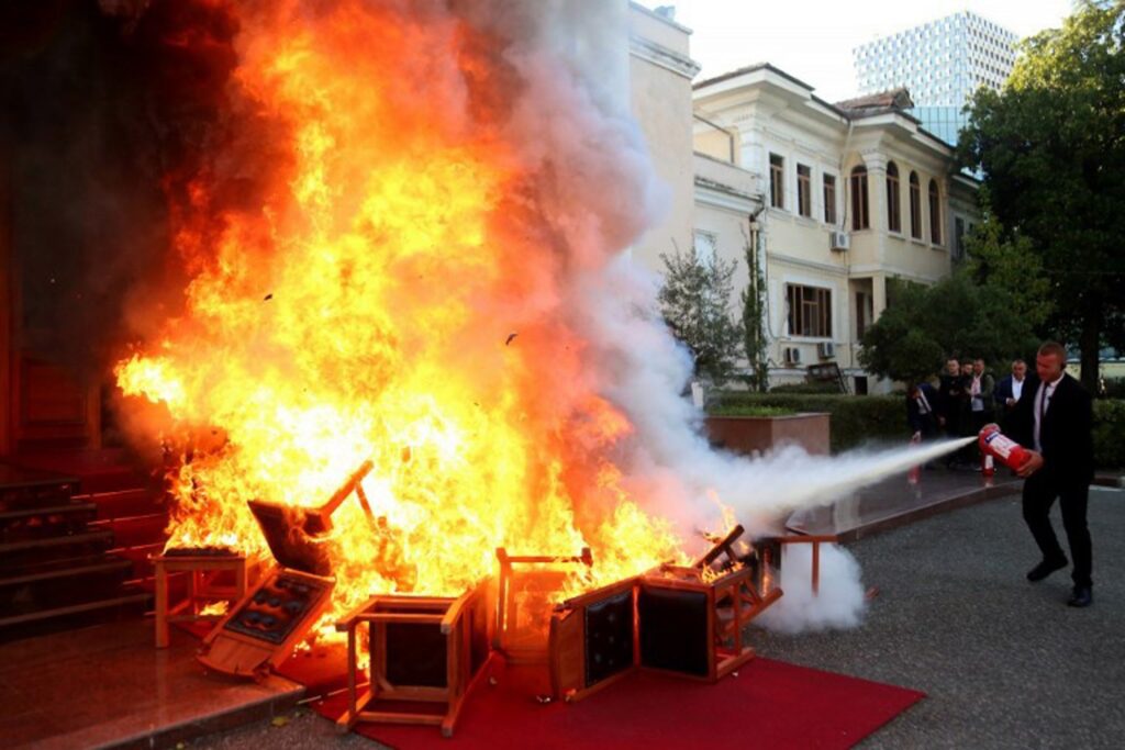 Opposition legislators set fire to chairs outside Albania's Parliament