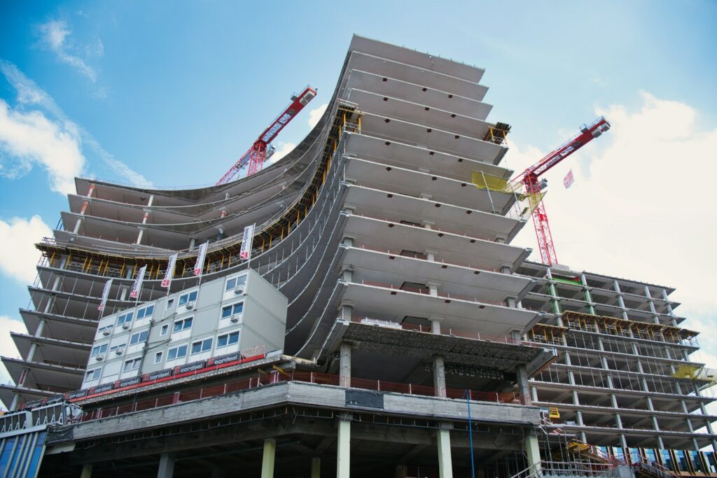 A large building under construction with cranes on top of it