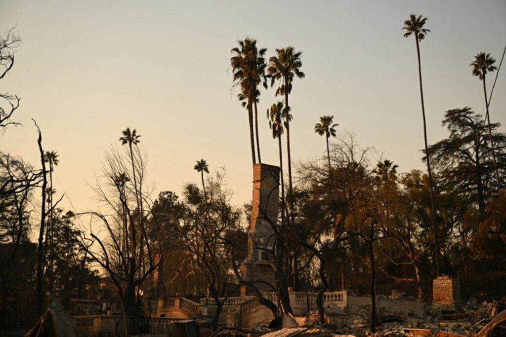 California fires: Wind dies down in LA but anger rises at public authorities