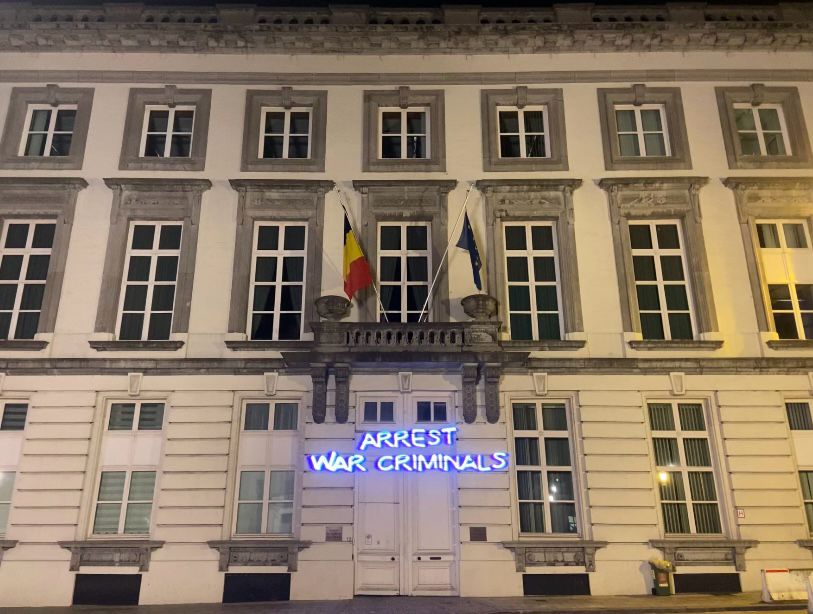 'Arrest war criminals' projected on Belgian Prime Minister's office