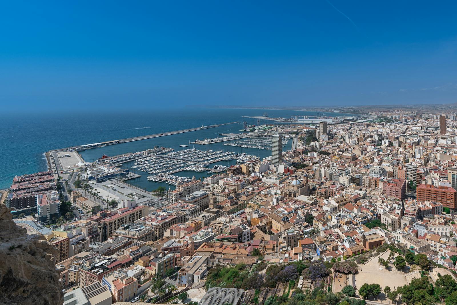 Stunning aerial view of Alicante's marina and cityscape under a clear blue sky.