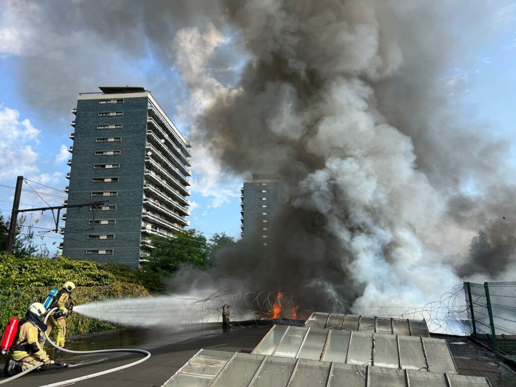 Firefighter hospitalised after huge warehouse fire