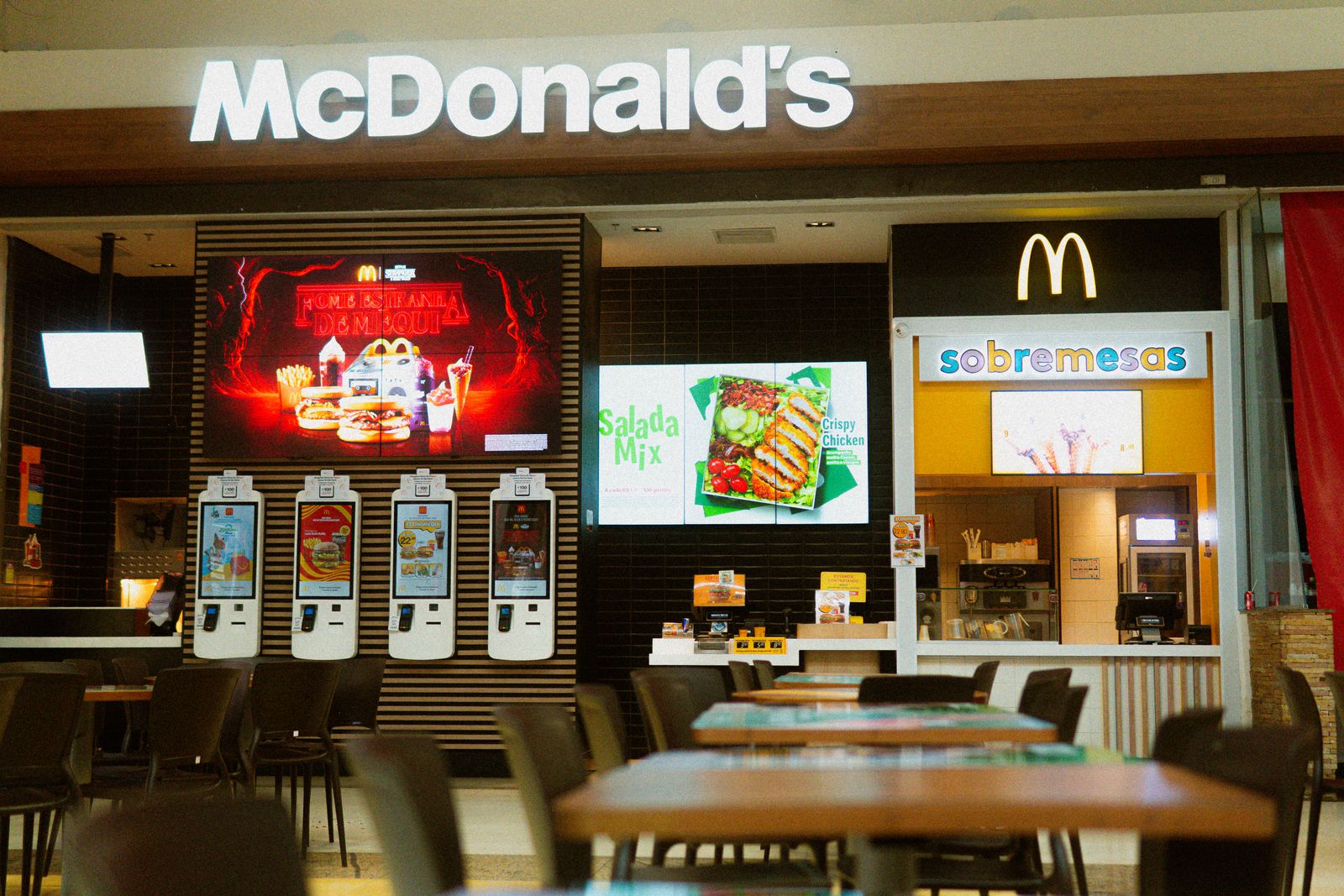 McDonald's fast food restaurant featuring self-service kiosks and digital menus.