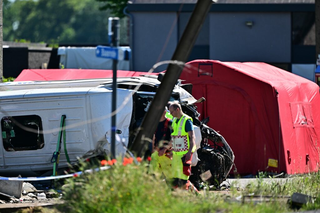 Four people dead after school bus hit by train at level crossing in Flanders