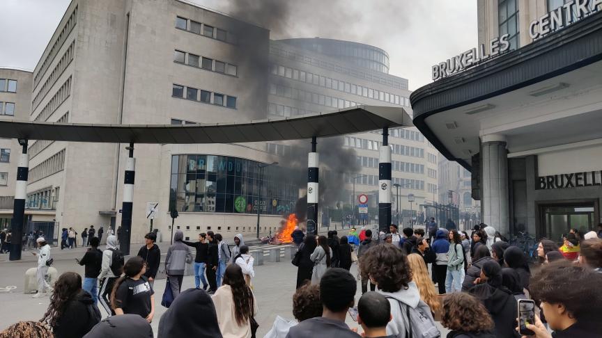 Student protesters light fire outside Brussels-Central station