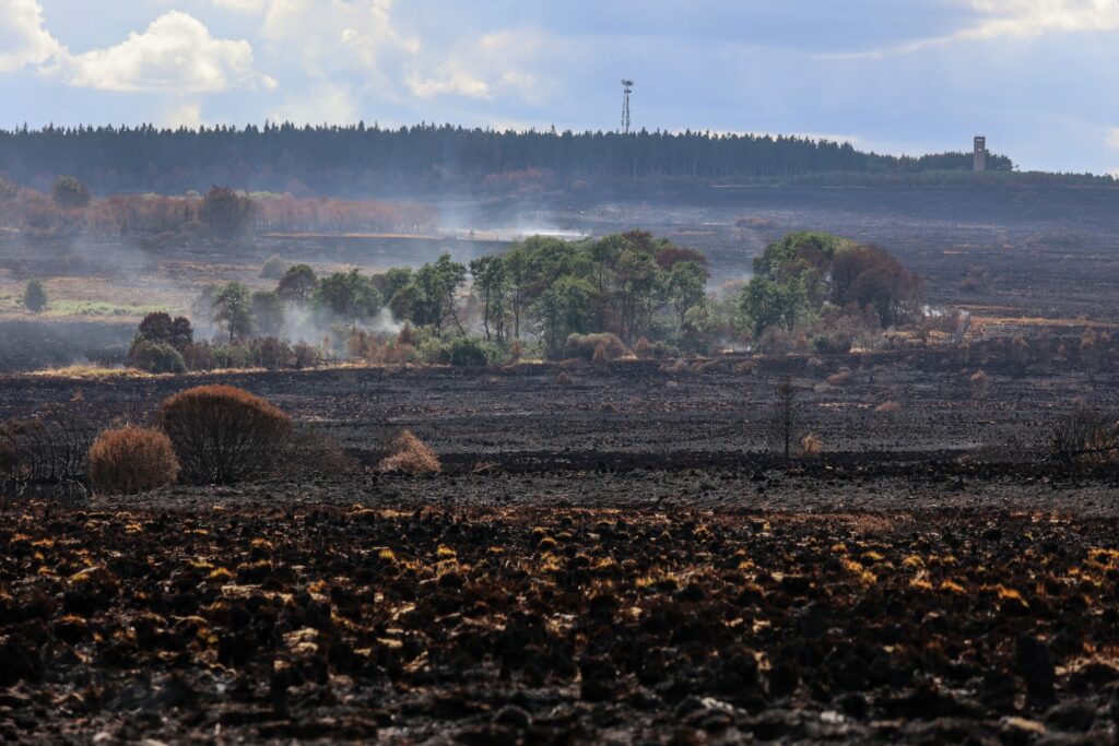 High Fens: Emergency services on the ground to monitor fire flare-ups